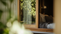 An exterior view of a wooden windowframe. An exterior view of a wooden windowframe.
